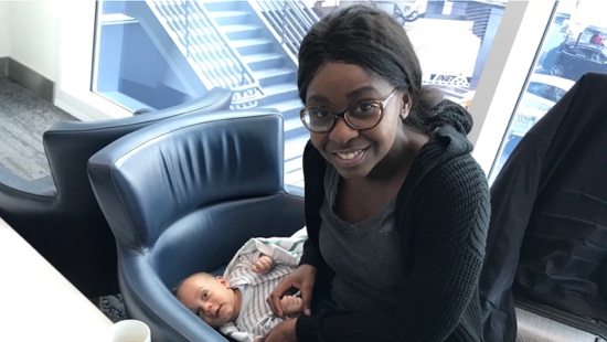A person sitting in a chair with a baby