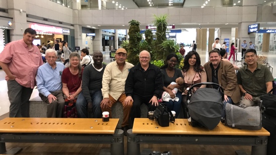 A group of people sitting on benches in a building