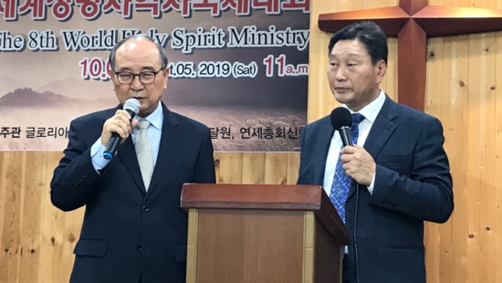Two men standing at a podium with microphones