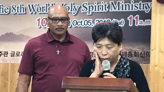A person and person standing behind a podium