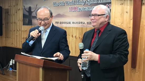 Two men standing at a podium with microphones
