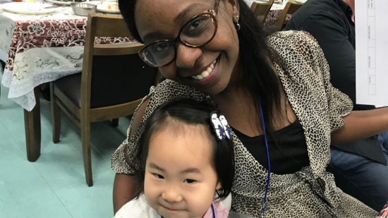 A person smiling with a baby