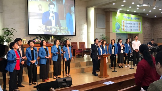 A group of people singing on stage