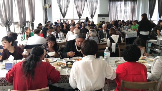 A group of people sitting at tables eating food