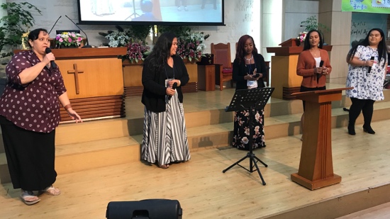 A group of women standing on a stage