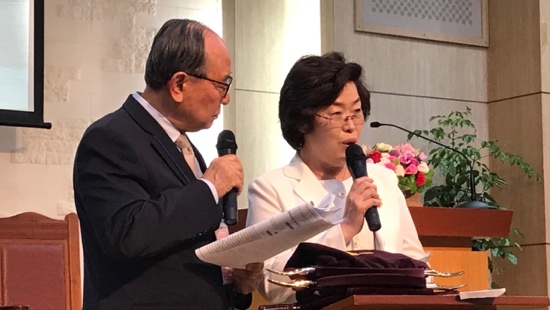 A person and person holding microphones