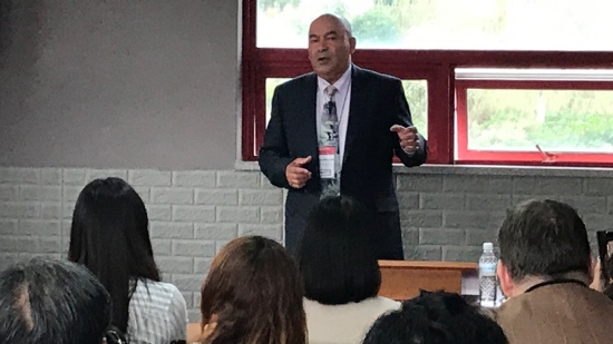A person in a suit standing in front of a group of people