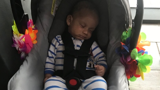 A baby sleeping in a car seat