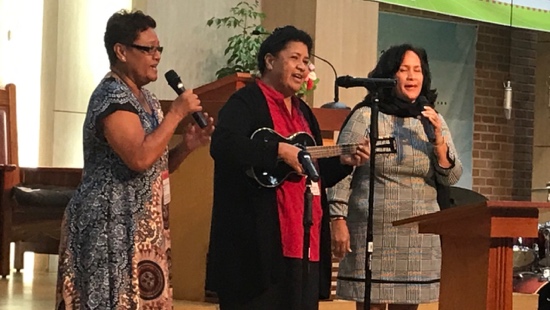 A group of women singing and singing
