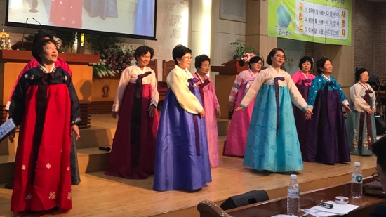 A group of women wearing colorful dresses