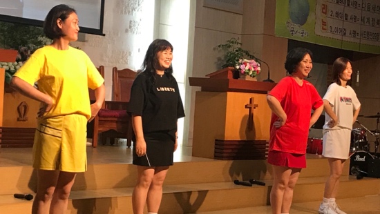 A group of people standing on a stage