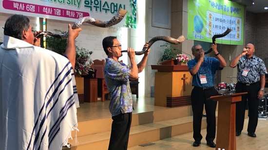 A group of men blowing a shofar