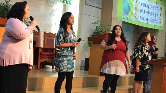 A group of women holding microphones
