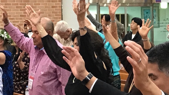 A group of people raising their hands