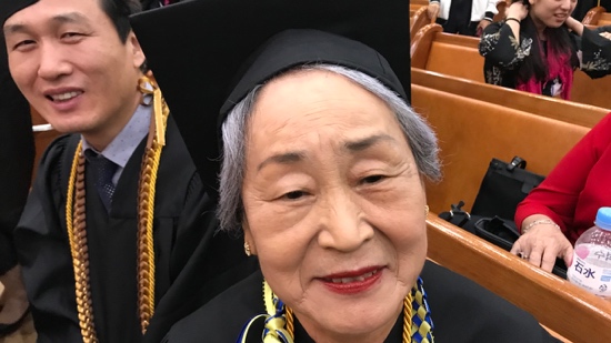 A person wearing a graduation cap and gown