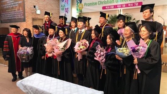 A group of people in graduation gowns and caps