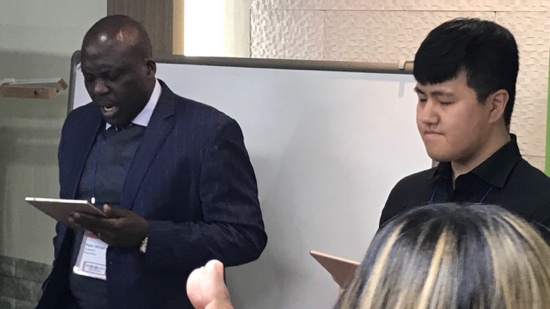 A person in a suit and tie standing next to a person in a suit