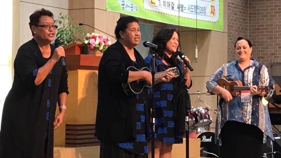 A group of people singing and playing instruments