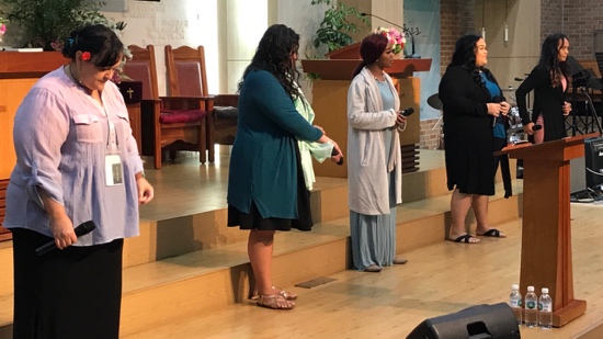 A group of women standing on a stage