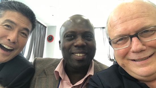 A group of men smiling for a selfie
