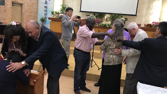 A group of people standing around each other