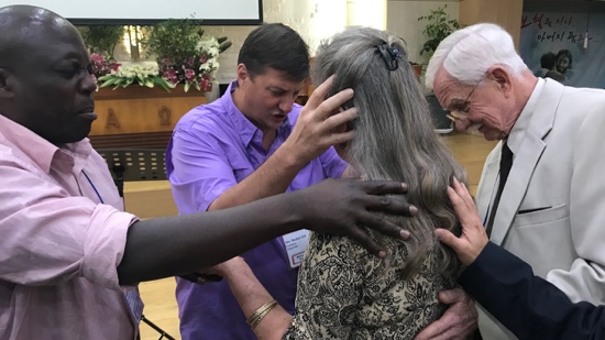 A group of people holding hands to a person