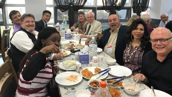 A group of people sitting around a table with food