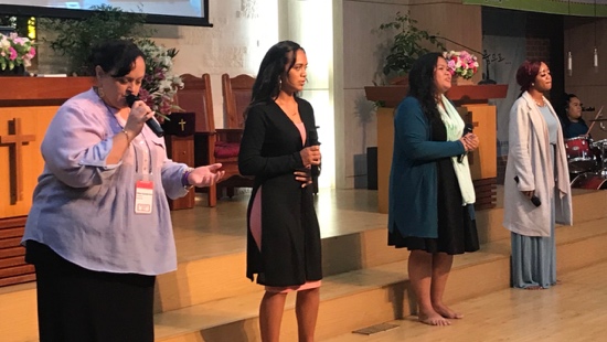 A group of women standing on a stage