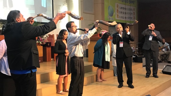 A group of people holding shofars