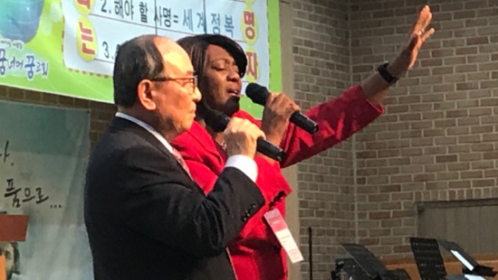 A person and person singing into microphones