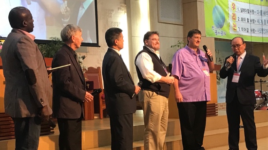 A group of men standing on a stage