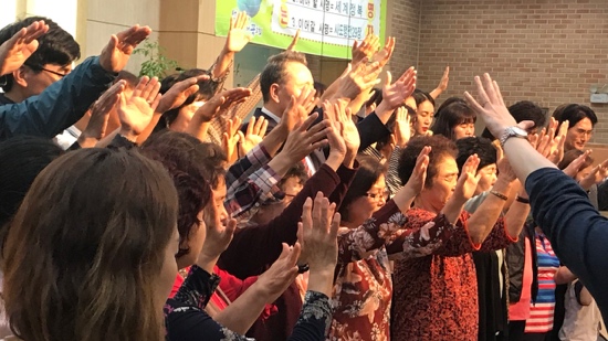 A group of people raising their hands