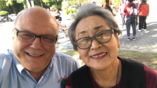 A person and person smiling for a picture