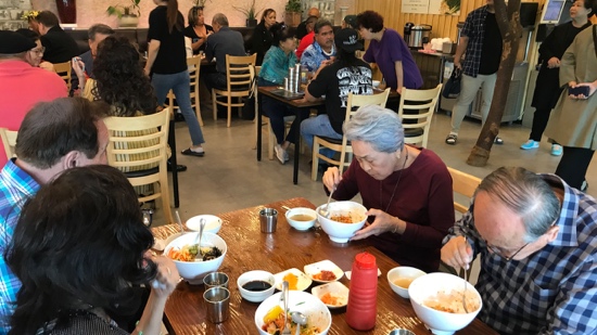 A group of people eating at a restaurant