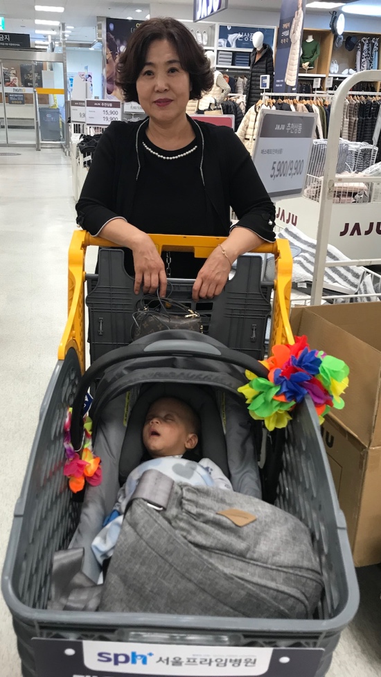 A person pushing a baby in a stroller