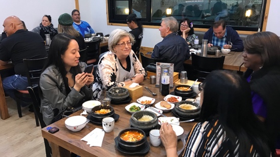 A group of people sitting around a table with food