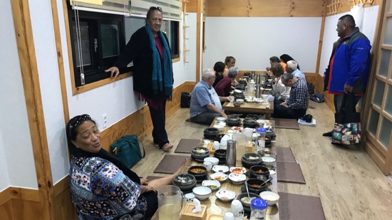 A group of people sitting at a table with food on it