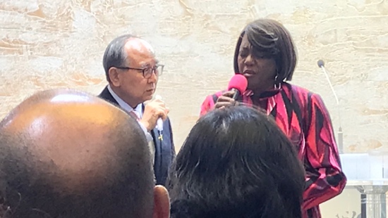 A person and person speaking into a microphone
