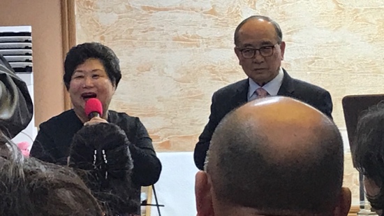 A person and person speaking into microphones