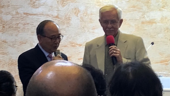 A person holding a microphone and another person holding a microphone
