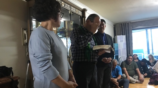 A person standing in a room with a person standing in front of him