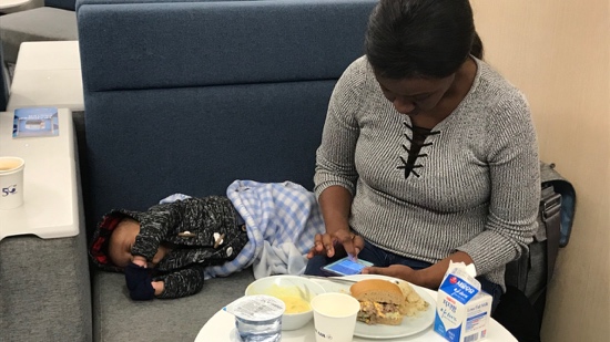 A person sitting next to a baby