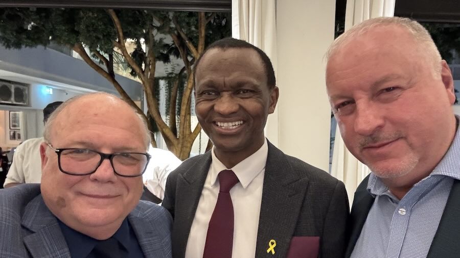 A group of men smiling for a photo
