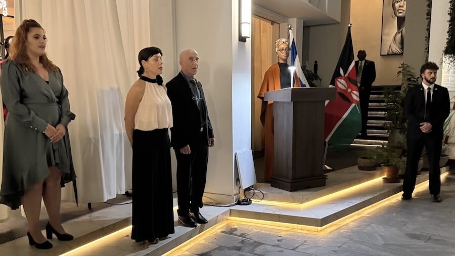 A person and person standing in front of a podium