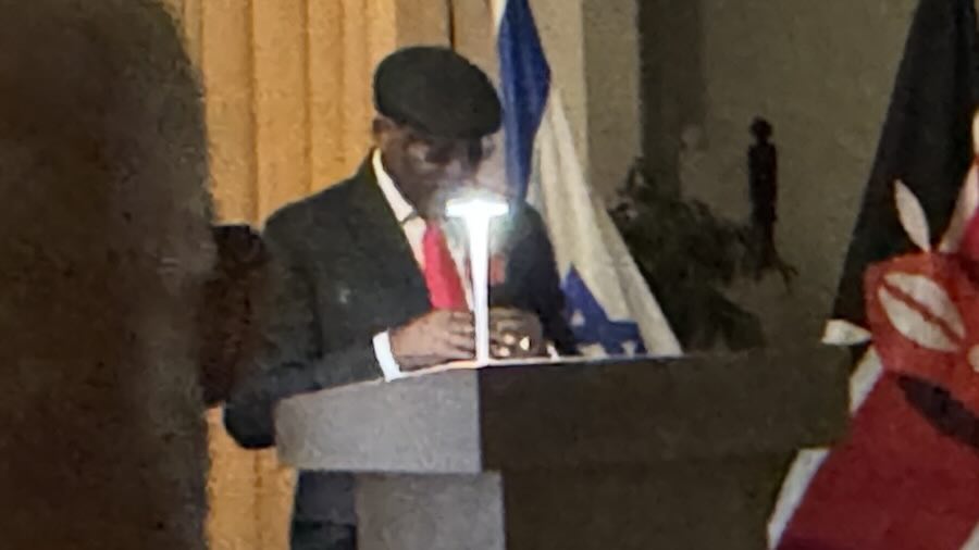 A person standing at a podium with a light on