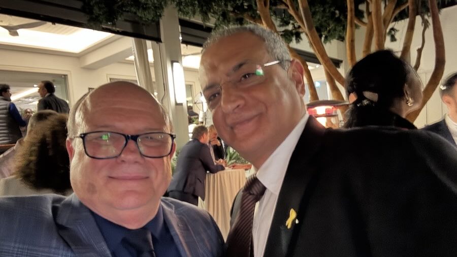 Two men standing together smiling