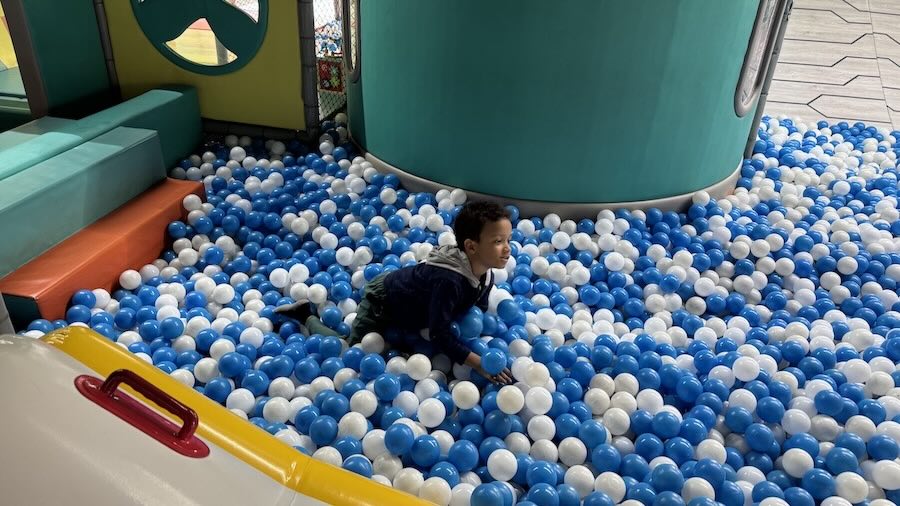 A child playing in a ball pit