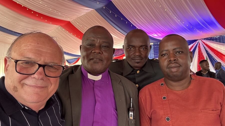 A group of men standing together in a tent
