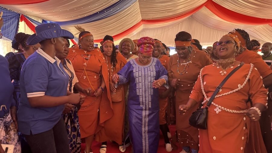 A group of people in orange outfits