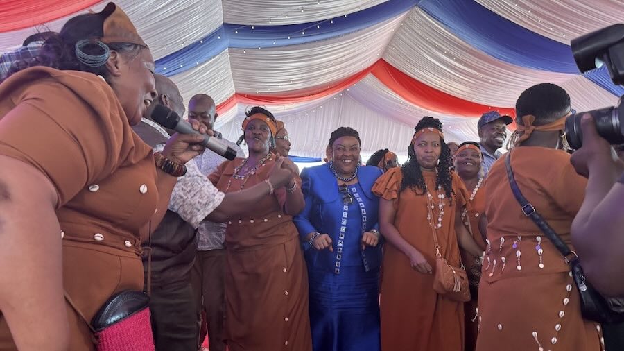 A group of people singing in a tent